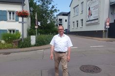 Bürgermeister Jürgen Dixius überquert die Hauptstraße im Stadtteil Beurig, dort, wo zukünftig die Lichtsignalanlage sicher über die Straße führen wird.