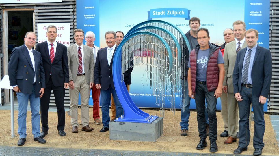 Über das neue Kunstwerk im Gartenschaupark Zülpich freuen sich (von links): Albert Stumm (Vorsitzender Förderverein Gartenschaupark Zülpich), Ulf Hürtgen (Bürgermeister der Stadt Zülpich), Christoph M. Hartmann (Geschäftsführer der Landesgartenschau Zülpich 2014 GmbH), Ernst Georg Fiege (Förderverein Gartenschaupark Zülpich), Franz Glasmacher (Ortsvorsteher Linzenich-Lövenich), Thomas Hellingrath (Prokurist Landesgartenschau Zülpich 2014 GmbH), Mark Prouse (Künstler), Jörg Schmitz (Baumschule Schmitz), Leo Wolter (Enzen), Dr. Peter Kramp (CEO Smurfit Kappa Zülpich Papier GmbH) und Ottmar Voigt (Beigeordneter der Stadt Zülpich).